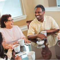 People around table drinking coffee